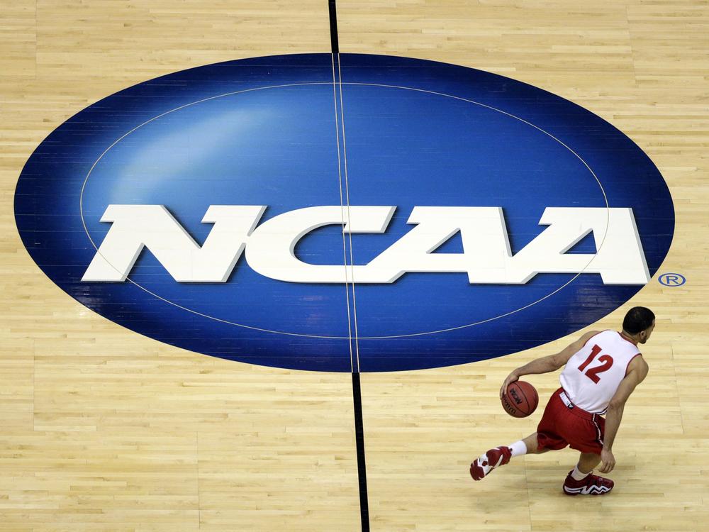 FILE - Wisconsin's Traevon Jackson dribbles past the NCAA logo during practice at the NCAA men's college basketball tournament March 26, 2014, in Anaheim, Calif.