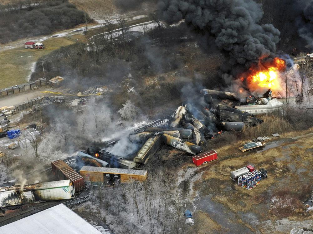 Debris from a Norfolk Southern freight train lies scattered and burning along the tracks on Feb. 4, 2023, the day after it derailed in East Palestine, Ohio. A federal judge has signed off Tuesday, May 21, 2024, on the $600 million class action settlement over last year's disastrous Norfolk Southern derailment in eastern Ohio, but many people who live near East Palestine are still wondering how much they will end up with out of the deal.