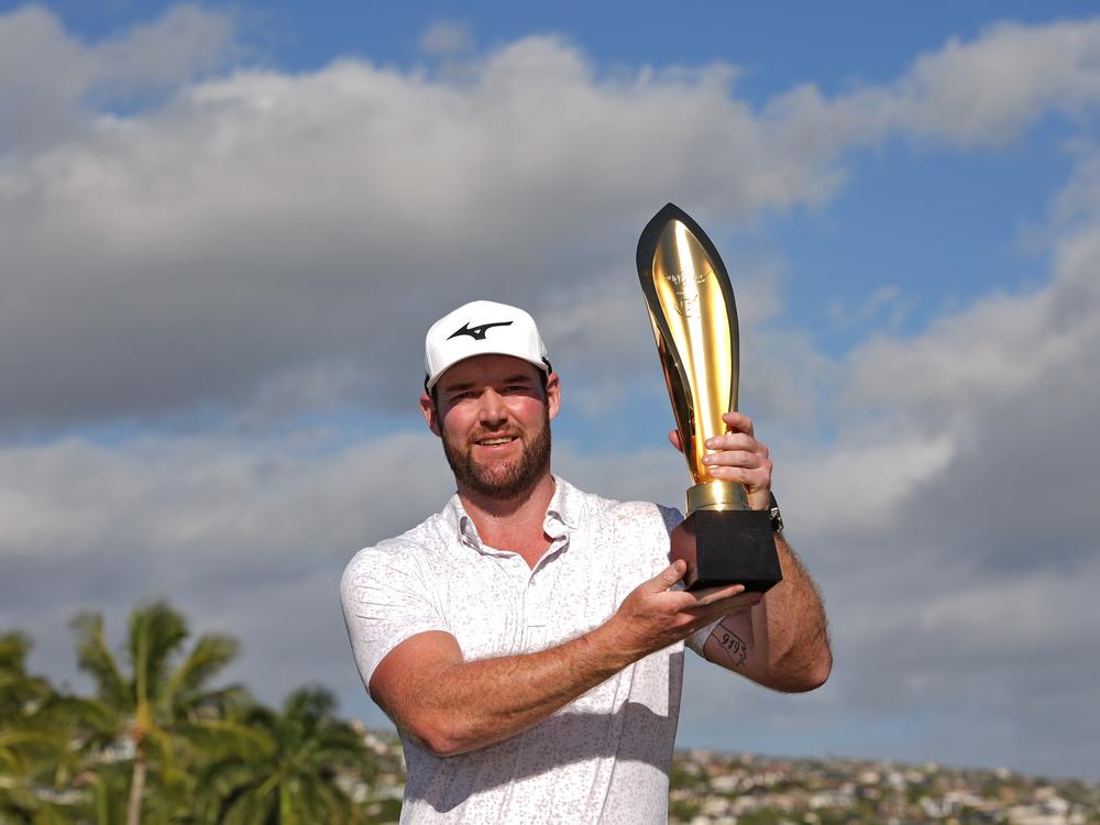 Grayson Murray holds the trophy after winning the Sony Open golf event, on Jan. 14, 2024, at Waialae Country Club in Honolulu. The 30-year-old died on Saturday, according to PGA Tour officials.