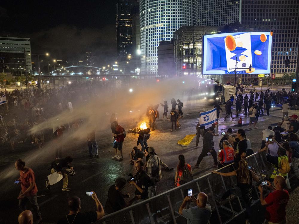 Police use water cannon to disperse demonstrators during a protest against Israeli Prime Minister Benjamin Netanyahu's government, and calling for the release of hostages held in the Gaza Strip by the Hamas militant group, in Tel Aviv, Israel, Saturday, May 25, 2024.