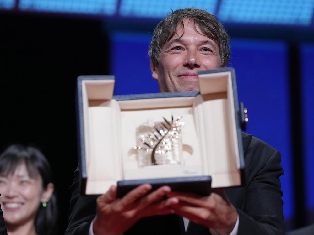 Sean Baker holds the Palme d'Or for the film <em>Anora</em>, during the awards ceremony of the 77th international film festival in Cannes, southern France, on Saturday.