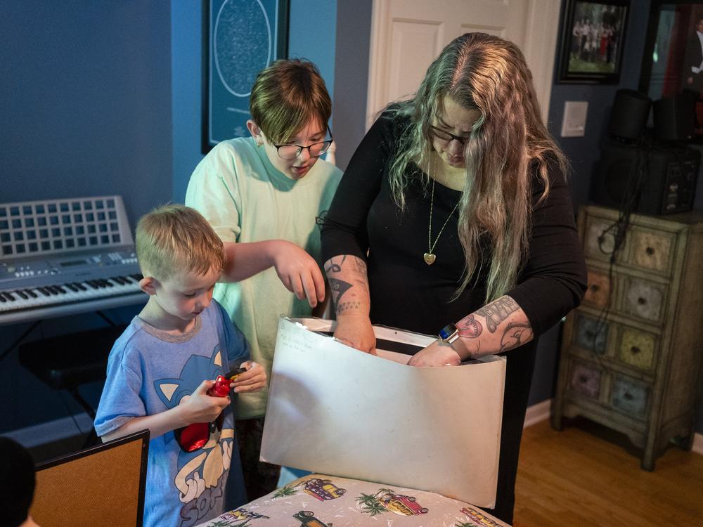 Xander and Jackson Moore look through belongings in a room dedicated to Alexander “AJ” Betts Jr. at home in Des Moines, Iowa. Sheryl J. Moore said Betts was enthusiastic about becoming an organ donor when he got his driver’s license. When he died at age 16, his heart, lungs, and liver were among the organs that helped prolong the lives of seven people, but his corneas went untouched. 