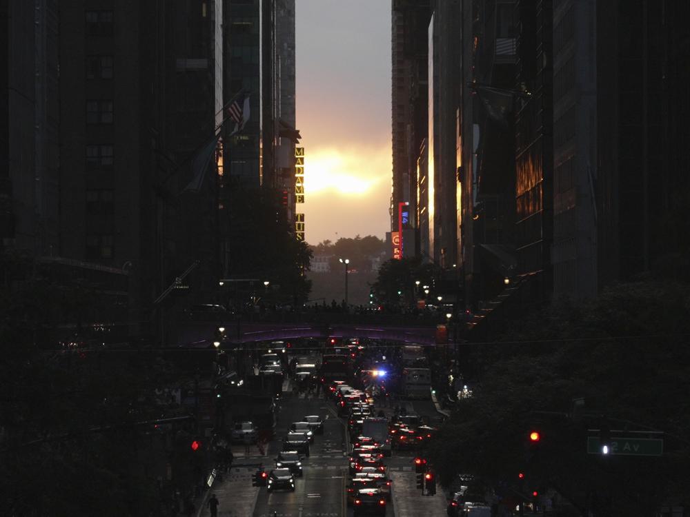 Clouds obscure the view of the setting sun on 42nd street in New York, Tuesday, May 28, 2024. Twice per year, New Yorkers and visitors are treated to a phenomenon known as Manhattanhenge, when the setting sun aligns with the Manhattan street grid and sinks below the horizon framed in a canyon of skyscrapers.