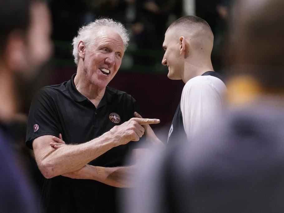 Basketball Hall of Fame legend Bill Walton, left, jokes with Denver Nuggets center Nikola Jokic in February 2022 during a practice session for the NBA All-Star basketball game in Cleveland. Walton, who starred for John Wooden's UCLA Bruins before becoming a Basketball Hall of Famer and one of the biggest stars of basketball broadcasting, died Monday, the league announced on behalf of his family. He was 71.