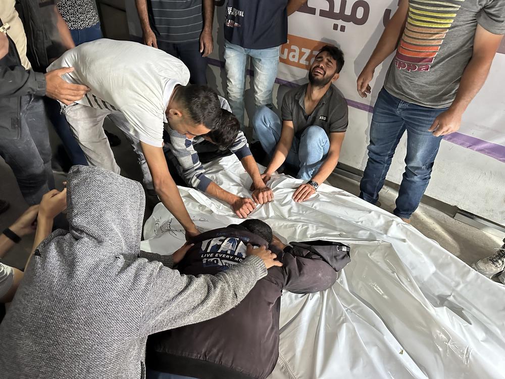  Palestinians grieve relatives who were killed in an Israeli airstrike on an encampment for displaced people on Sunday, May 26, in the southern Gaza city of Rafah. Gaza health officials say 35 people were killed in the strike.