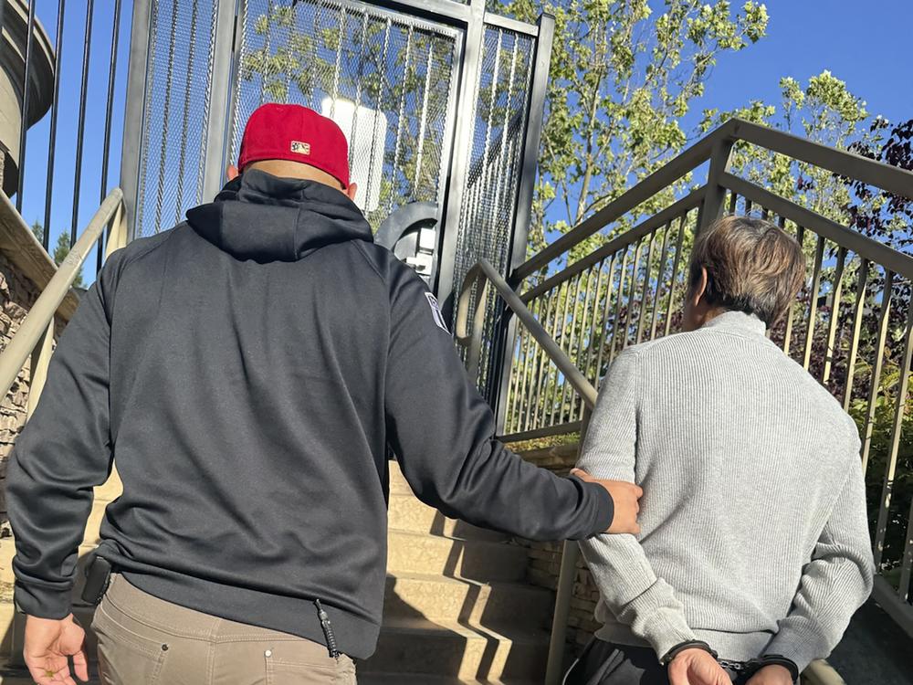 Tuen Kit Lee is led away in handcuffs on Tuesday, May 28, 2024, in Danville, Calif. The fugitive dubbed the 