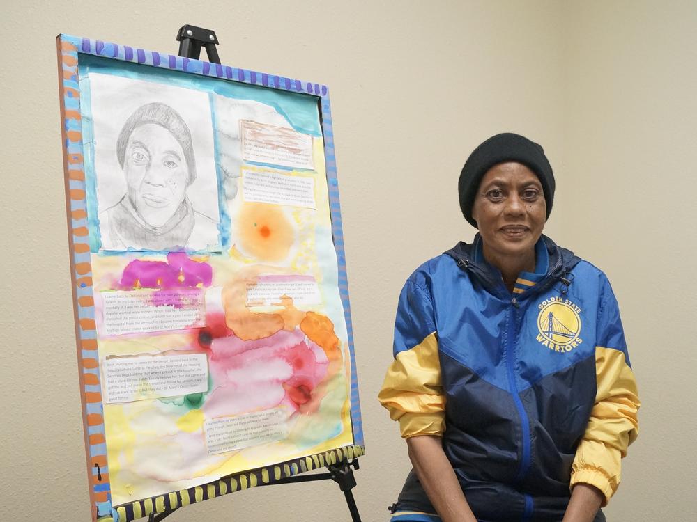 Donna Patterson poses by artwork she created as part of the Sacred Storytelling Art Project through St. Mary’s Center and the Center for ArtEsteem in Oakland, Calif. The program encourages seniors to create art that reflects their life story. Through her art, Patterson communicates about caretaking for her grandparents at their end of life in North Carolina. <br>