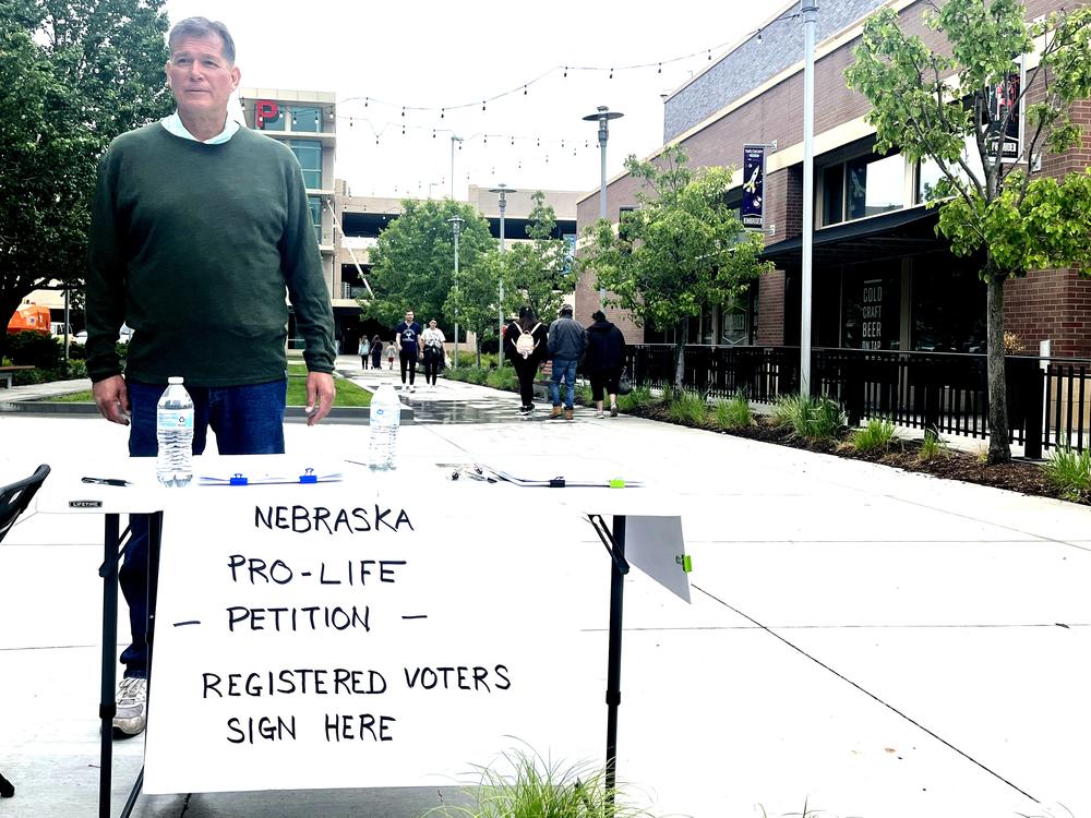  At a farmers’ market in midtown Omaha, Richard Riscol solicits signatures for a petition to put a constitutional amendment on the ballot that would limit abortion at 12 weeks of pregnancy.