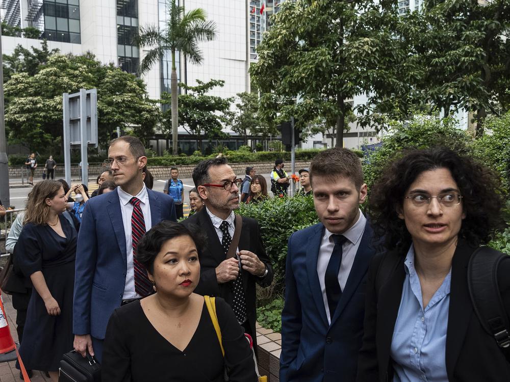 Representatives from various consulates wait outside the West Kowloon Magistrates' Courts in Hong Kong on Thursday.