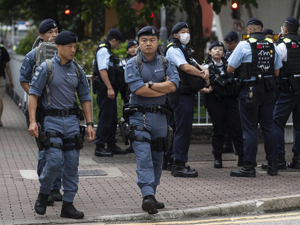 Police officers stand guard outside the West Kowloon Magistrates' Courts in Hong Kong on Thursday. 