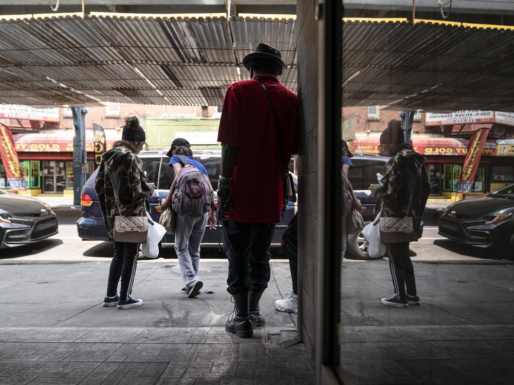 People gather outside the Savage Sisters' community outreach storefront in the Kensington neighborhood of Philadelphia. The area is being hit hard by Medetomidine and Xylazine, powerful sedatives most often used by veterinarians that are moving through the illicit drug supply triggering 