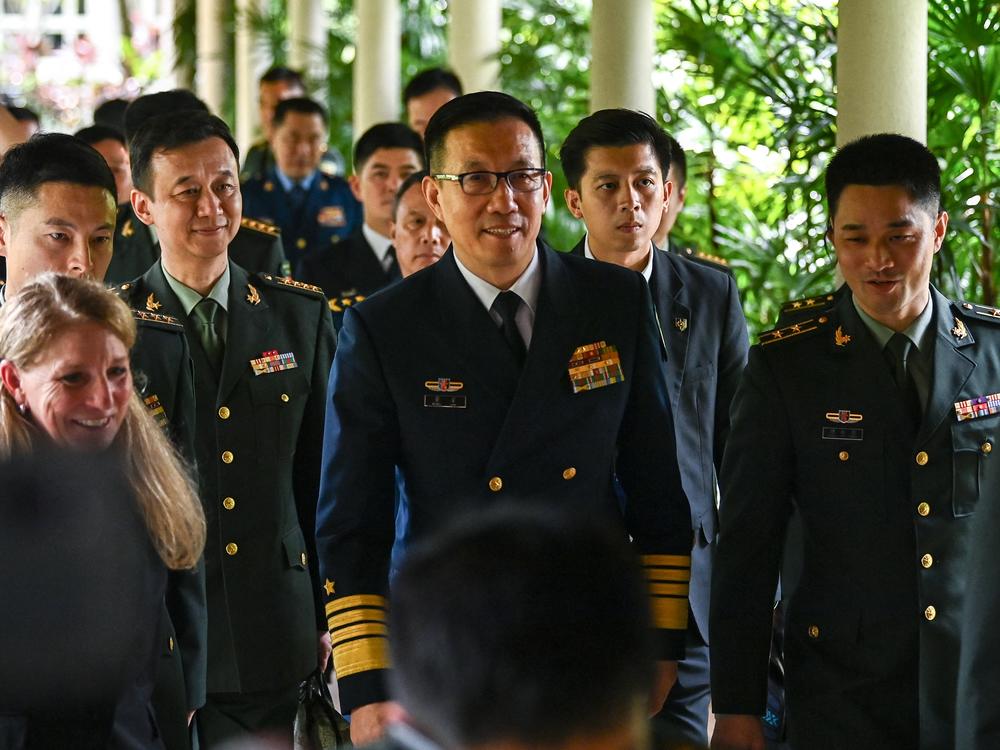 China's Defense Minister Dong Jun, center, walks out after a bilateral meeting with U.S. Secretary of Defense Lloyd Austin on the sidelines of the 21st Shangri-La Dialogue summit at the Shangri-La Hotel in Singapore on Friday.