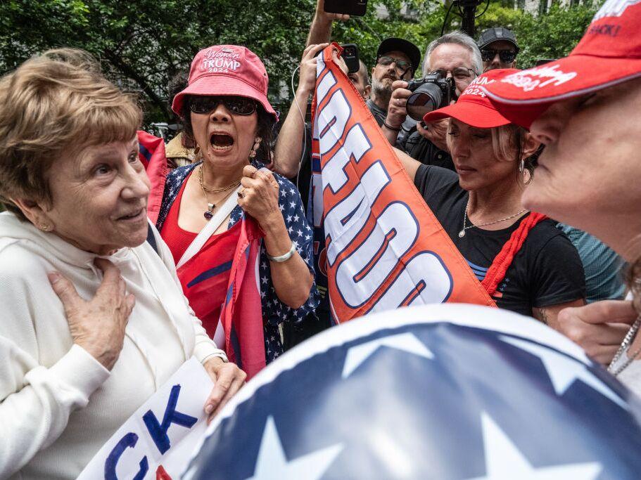 Trump supporters and their opponents spar outside of the criminal court where the former president is on trial on Wednesday in New York City. 