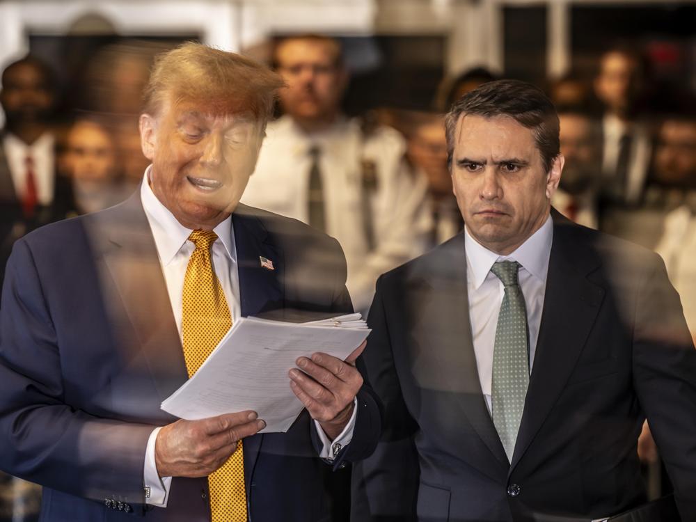 Former U.S. President Donald Trump speaks to the media as he arrives with attorney Todd Blanche.