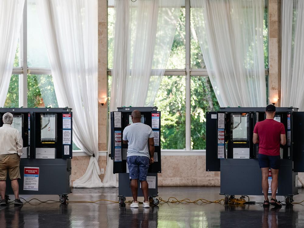 Voters cast ballots in Georgia's primary election at a polling location on May 21, 2024 in Atlanta. Many officials and researchers worry that audio deepfakes of politicians could be used to sway elections this year. 