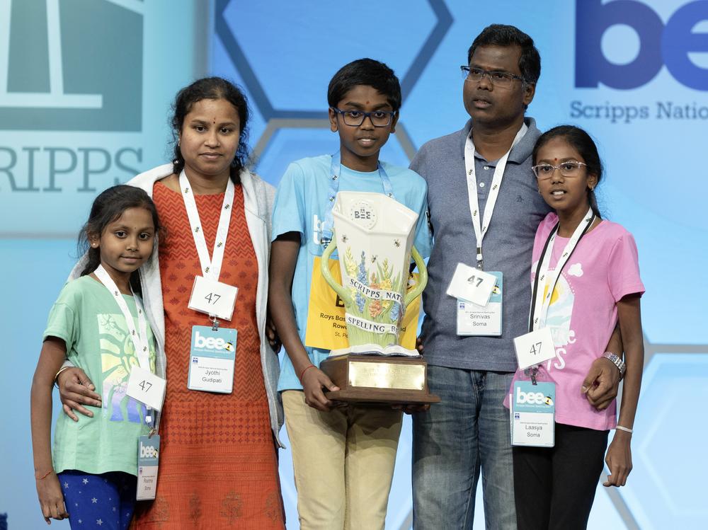Bruhat Soma, 12, of Tampa, Fla., stands on stage with his family after winning the Scripps National Spelling Bee, in Oxon Hill, Md., on Thursday night. 