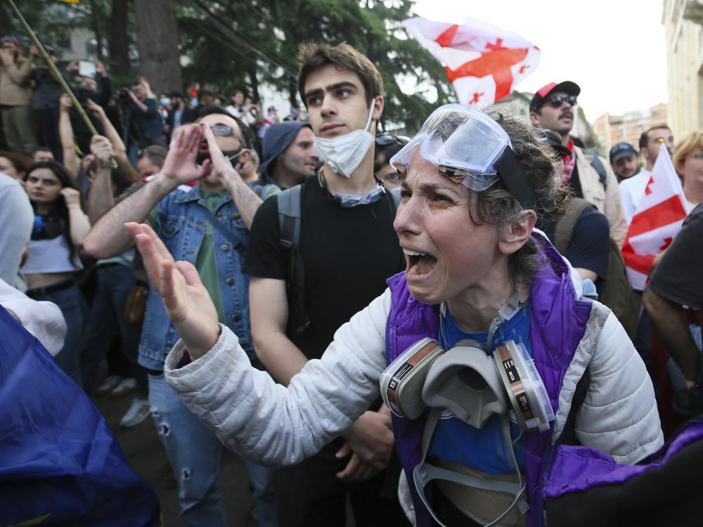 A demonstrator argues with police officers during a protest against the foreign influence bill at the Parliamentary building in Tbilisi, Georgia, on Tuesday, May 28, 2024. The Georgian parliament has overridden a presidential veto of the 