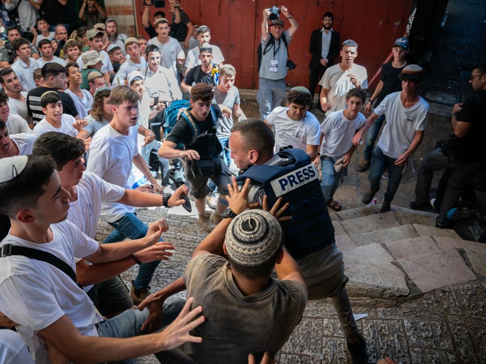 Israeli ultra-nationalist youth attack a Palestinian journalist ahead of the march in the Muslim Quarter of the Old City of Jerusalem. 
