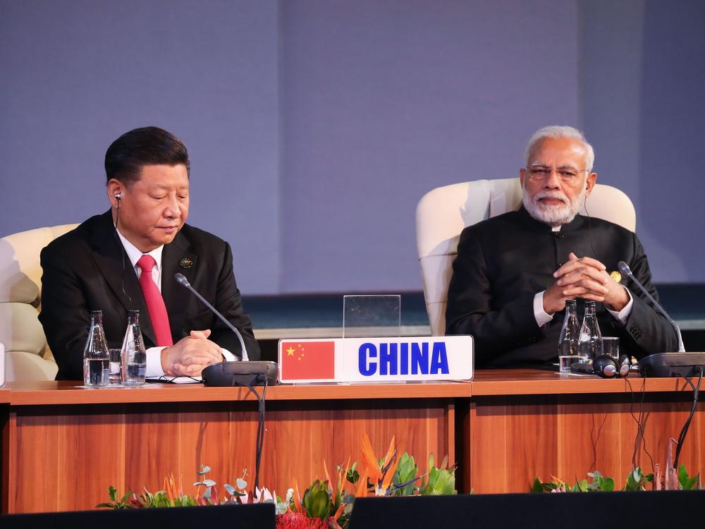 (LtoR) China's President Xi Jinping and India's Prime Minister Narendra Modi attend a session meeting during the 10th BRICS summit (acronym for the grouping of the world's leading emerging economies, namely Brazil, Russia, India, China and South Africa) on July 27, 2018 in Johannesburg, South Africa.