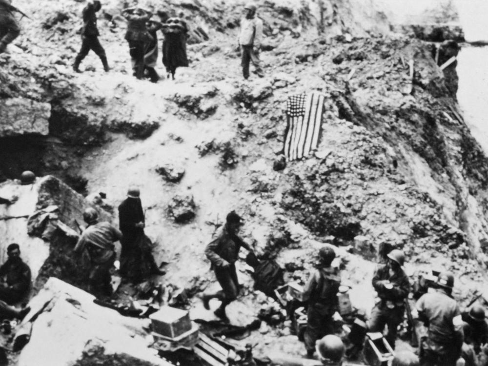 U.S. soldiers from the 2nd Ranger Battalion surround German prisoners on the Pointe du Hoc on D-Day.