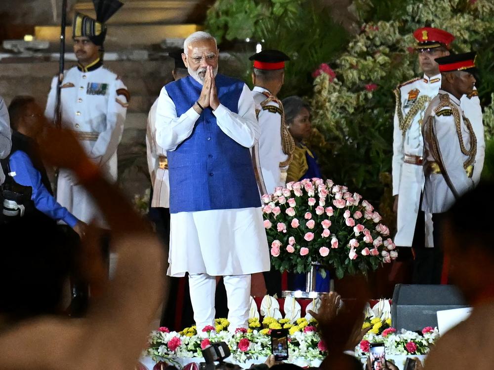 Prime Minister Narendra Modi gestures to the gathering during the oath-taking ceremony at presidential palace Rashtrapati Bhavan in New Delhi on Sunday.