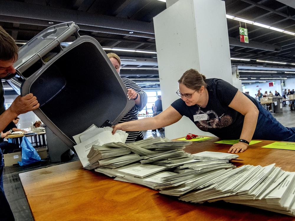 Elections workers empty a bin to count postal ballots for the European Union elections in Frankfurt, Germany, on Sunday.