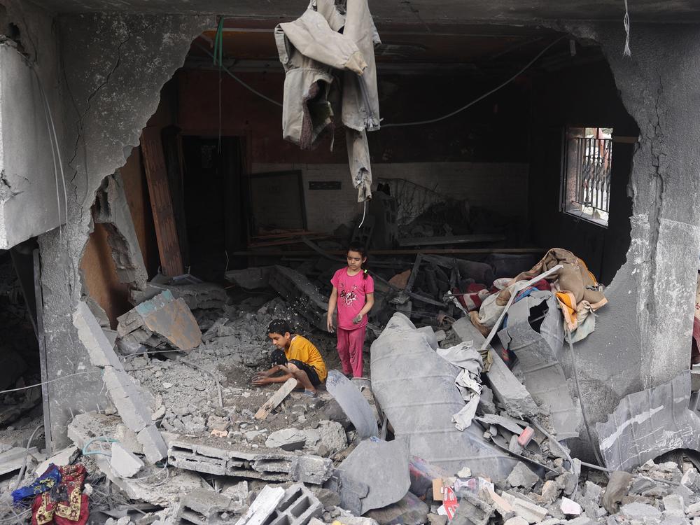 Palestinian children search through the rubble a day after an Israeli military operation in the Nuseirat refugee camp in central Gaza. Palestinian officials said well over 200 Palestinians were killed, many of them civilians. Israel freed four hostages who had been held since last October.