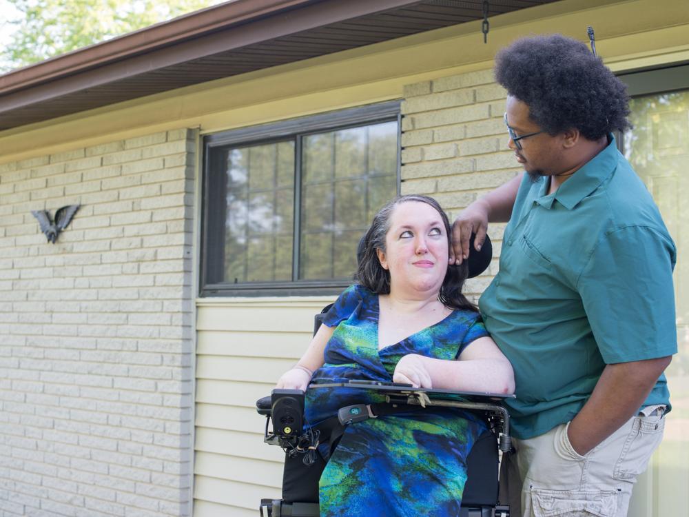 Garbero looks at her partner, Juan Johnson, outside their home. The two would like to get married, but their combined income would exceed the SSI $3,000 asset limit for a couple. The limit has not changed since 1989.