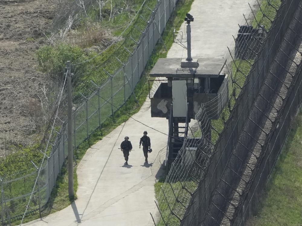 South Korean army soldiers patrol along the barbed-wire fence in Paju, South Korea, near the border with North Korea, on April 23, 2024.