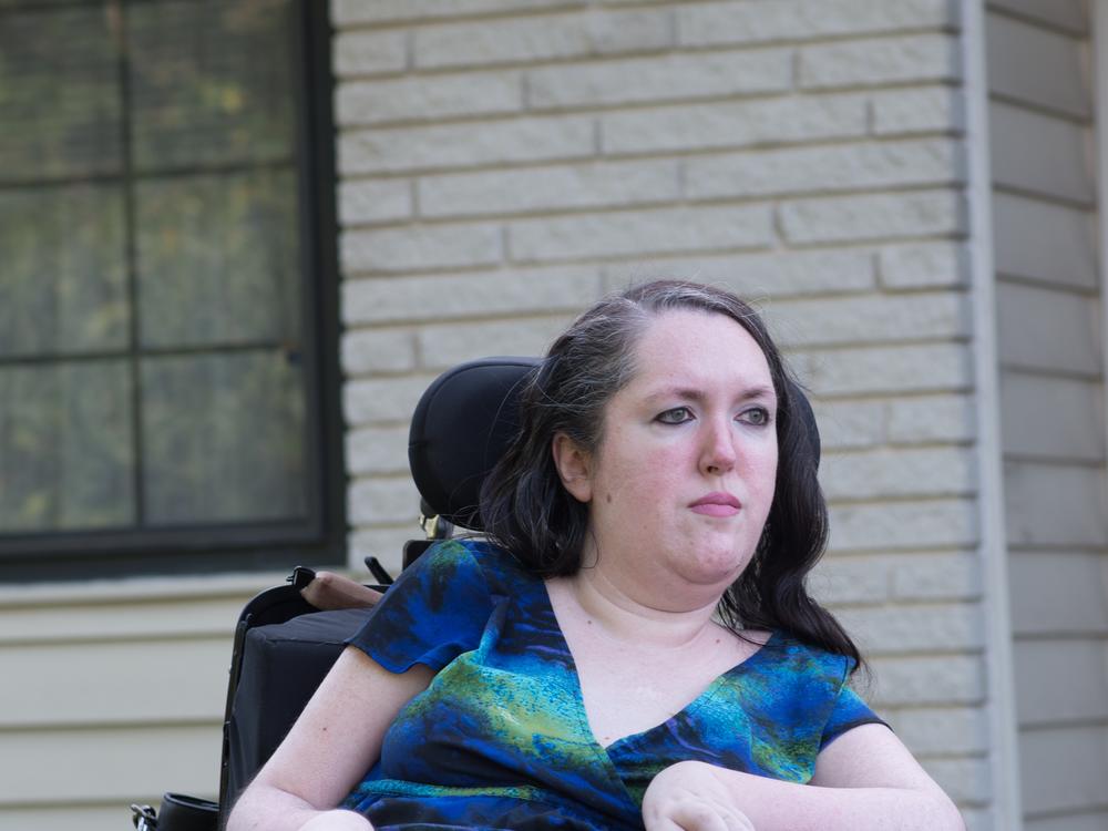 Gabriella Garbero poses for a portrait outside her home. She received her law degree from Saint Louis University School of Law and passed the bar in 2023. But she has not been able to take on new clients because it will likely put her over the SSI asset limit.
