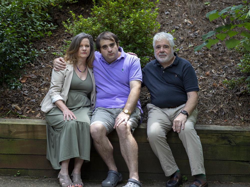 Ramirez sits with son Ryan (center) and husband Dan Crimmins. Stacey and Dan are both professional disability consultants who work with other families on applying for SSI benefits — but they had difficulty making SSI work for Ryan.