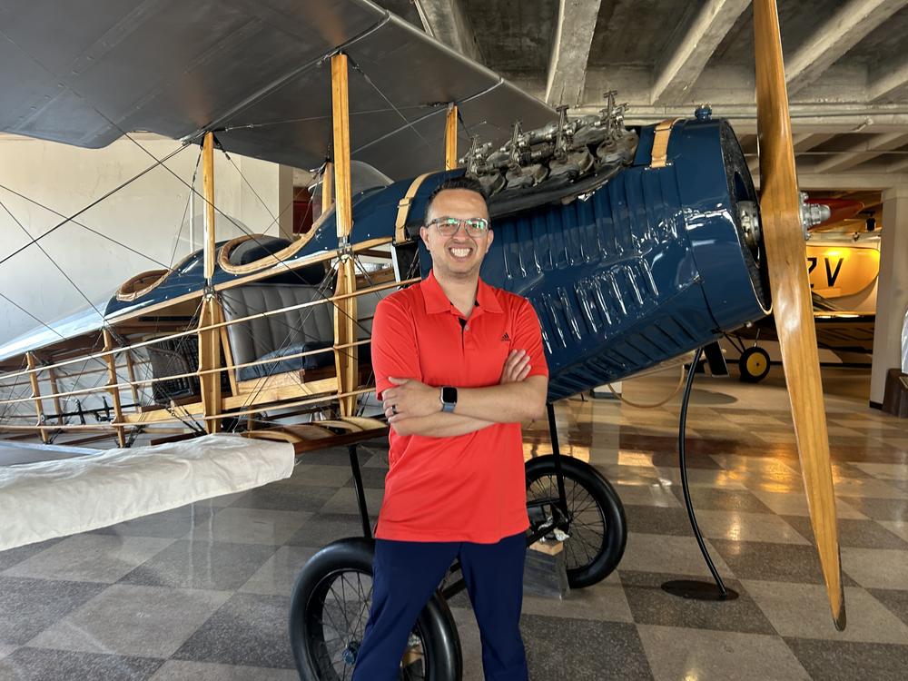  Kansas Aviation Museum president Ben Sauceda stands next to a replica of a Laird Swallow, originally produced in Wichita in the 1920s. 