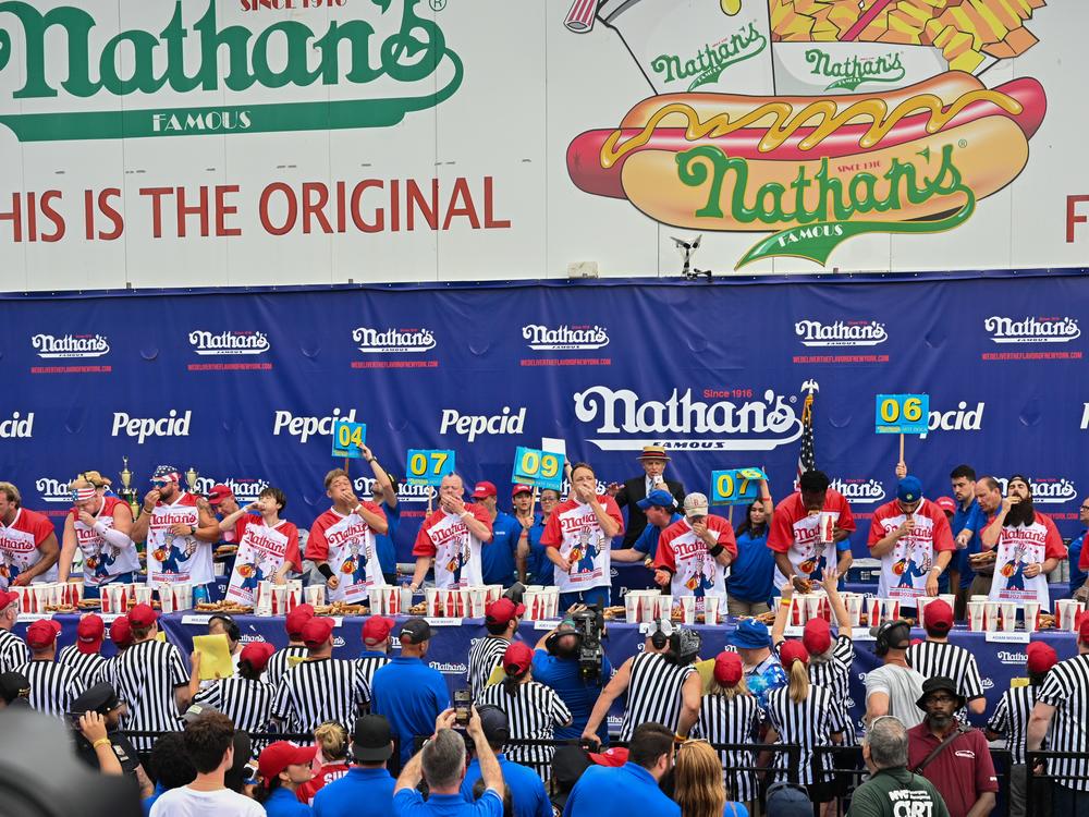 Men compete during the 2023 Nathan's Famous Fourth of July International Hot Dog Eating Contest on July 4, 2023 at Coney Island in the Brooklyn borough of New York City. 