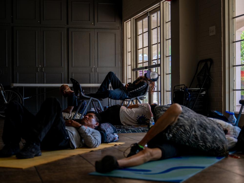 People seek shelter from the heat at a church in Phoenix in July 2023. Data about heat-related fatalities has helped spur emergency managers across the U.S. to open cooling centers on hot days. More detailed data about such deaths could help officials decide where to open such centers and how to ensure vulnerable people can access them.