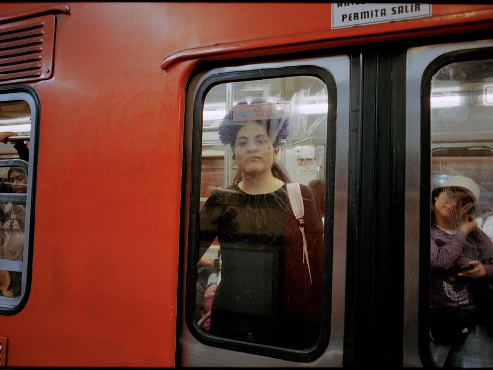A woman in the window of a women-only metro car in Mexico City on October 2023.