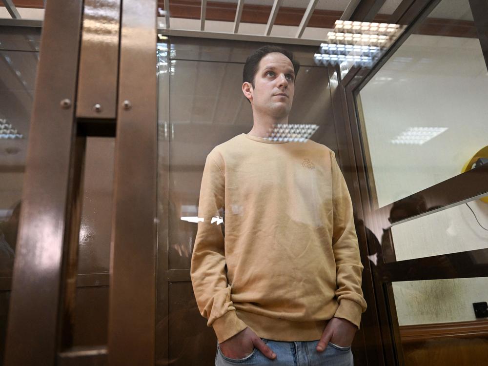 U.S. journalist Evan Gershkovich stands inside a defendants' cage during a pretrial detention hearing at the Moscow City Court in Moscow on Sept. 19, 2023. Gershkovich was detained during a reporting trip in Russia in March 2023 and accused of spying — charges that he, the U.S. government and his employer, <em>The Wall Street Journal</em>, vehemently deny. 