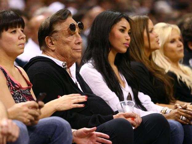 Former Los Angeles Clippers team owner Donald Sterling and V. Stiviano watch the San Antonio Spurs play against the Memphis Grizzlies during the Western Conference Finals of the 2013 NBA Playoffs