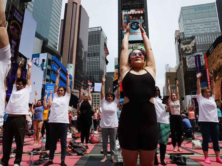 People participate in a mass yoga session on International Yoga Day in Times Square on June 21, 2023 in New York City. The CDC finds about 1 in 6 adults in the U.S. practice yoga.