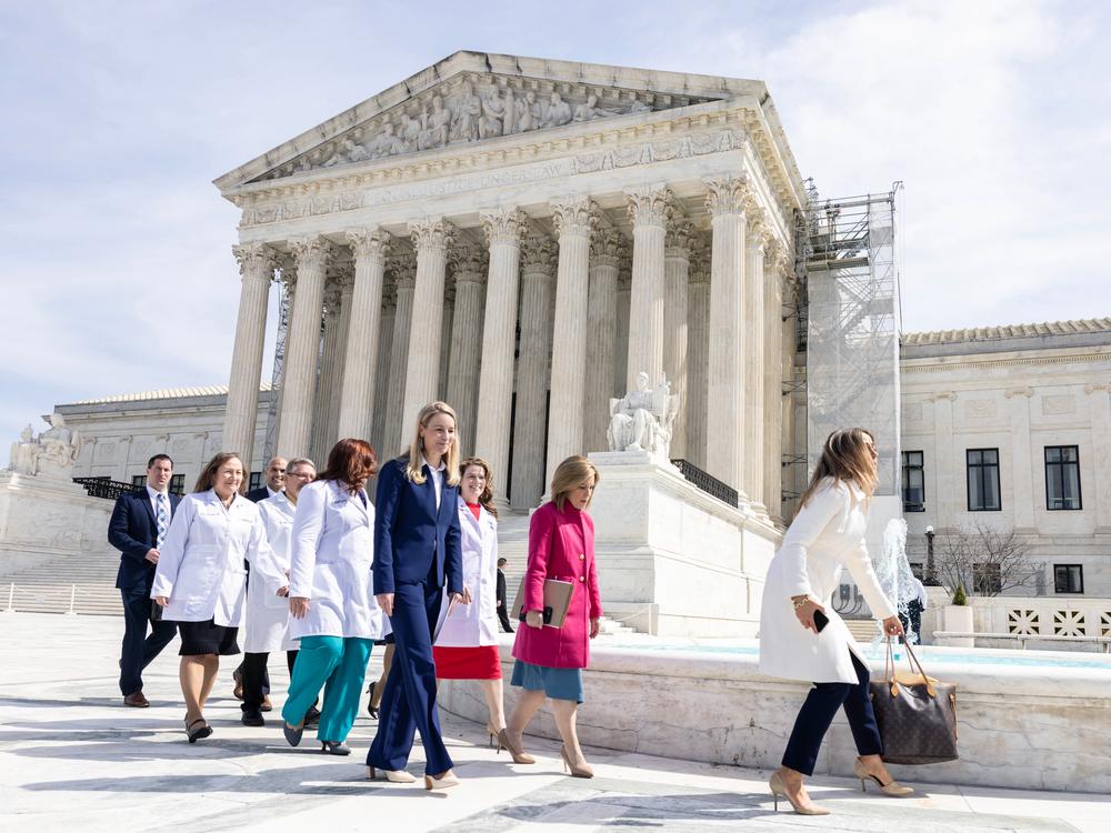 Erin Hawley (in blue), a Missouri attorney representing the Alliance for Hippocratic Medicine, departs the Supreme Court following oral arguments in Washington, D.C.