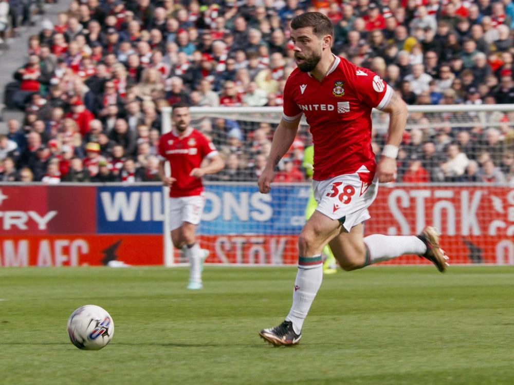  Elliot Lee moves the ball for Wrexham.