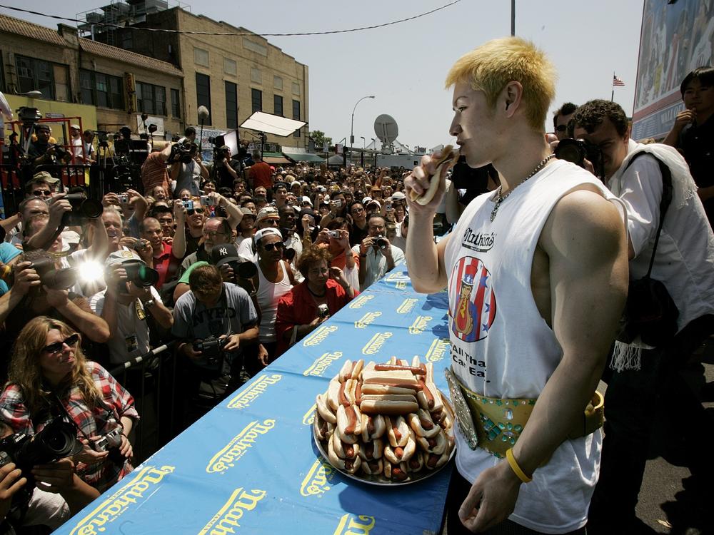 Takeru Kobayashi poses for the cameras after winning the annual Fourth of July International Hot Dog Eating Contest at Nathan's Famous on Coney Island on July 4, 2005.