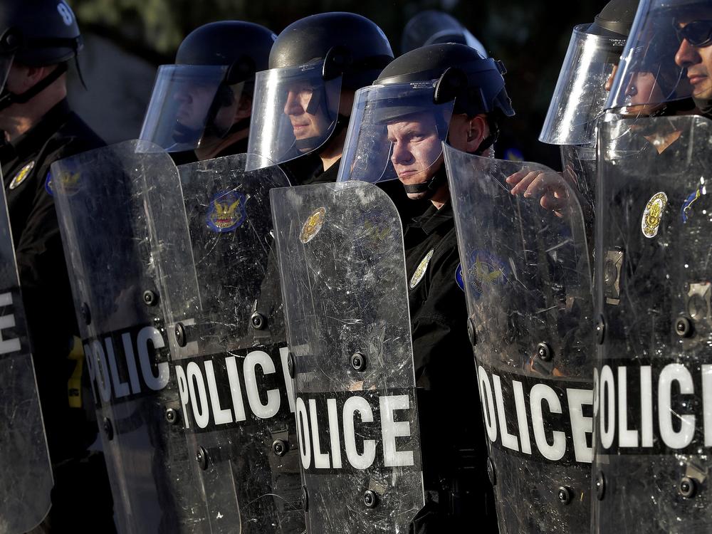 Phoenix Police officers watch protesters rally on June 2, 2020, during demonstrations over the death of George Floyd. 
