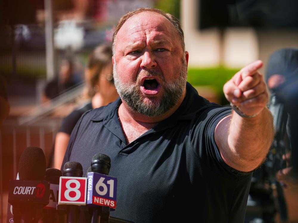 Infowars founder Alex Jones speaks to the media outside Waterbury Superior Court during his 2022 defamation trial in Waterbury, Conn.