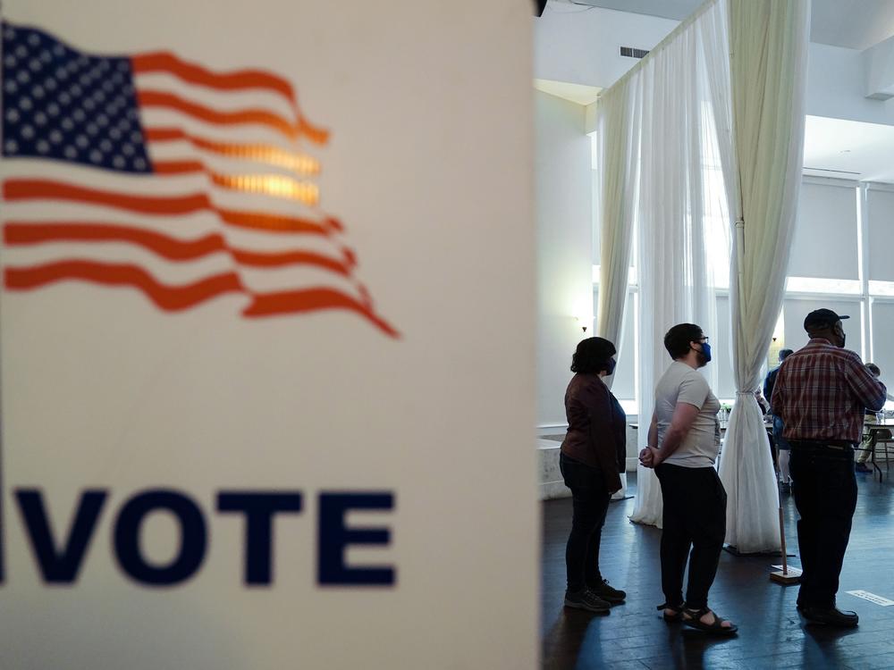 People wait in line to vote in Georgia's 2022 primary election in Atlanta.