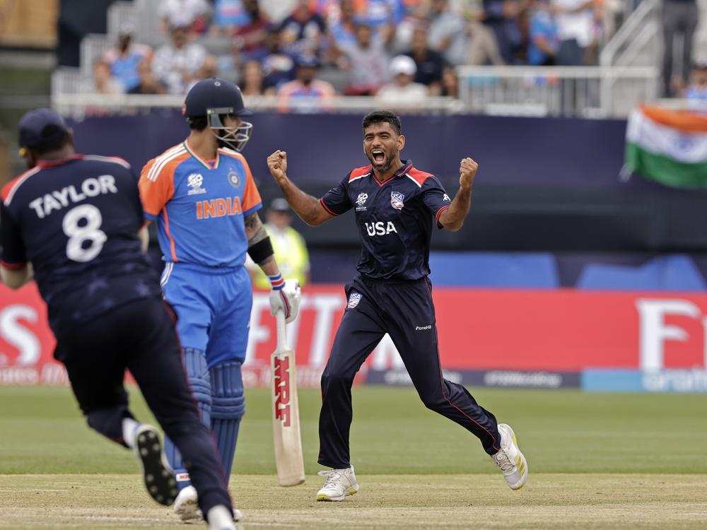 Saurabh Netravalkar, right, has become the breakout star of the U.S. national cricket team due to heroics like his dismissal of Indian superstar cricketer Virat Kohli, center, during Wednesday's match between the U.S. and India at the Nassau County International Cricket Stadium in New York. 