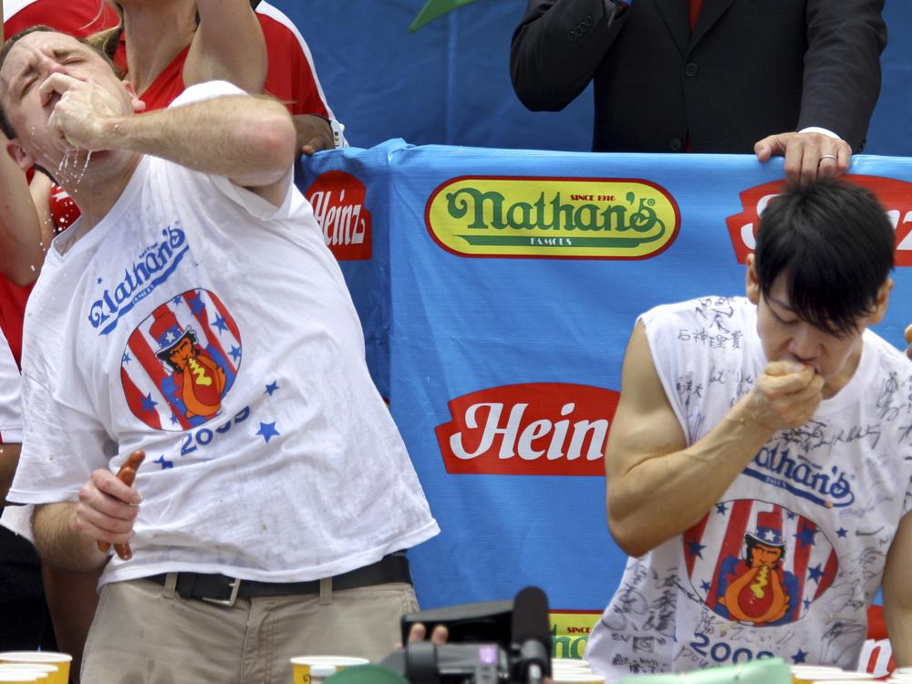 Joey Chestnut (L) and Takeru Kobayashi (R) compete in the Nathan's hot dog-eating contest on July 4, 2009, in New York. 