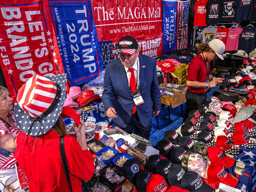 A vendor sells 2024 Donald Trump campaign souvenirs at the Turning Point Action USA conference in West Palm Beach, Flo., in 2023.