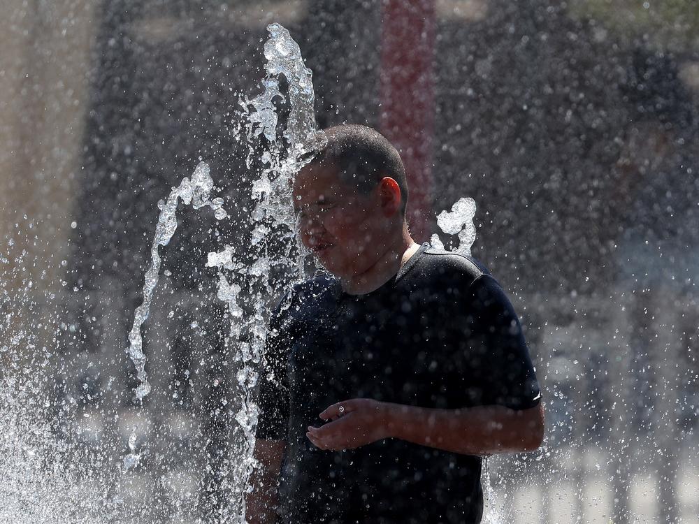 A boy plays in a splash pad at Riverview Park on June 5 in Mesa, Ariz.