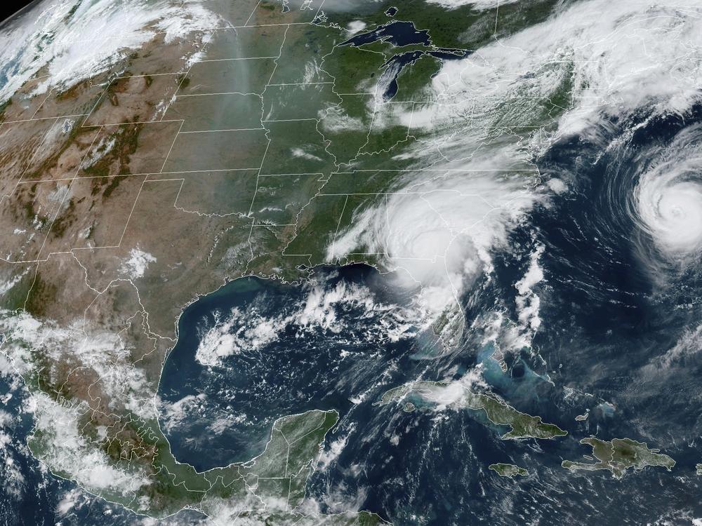 A satellite image provided by the National Oceanic and Atmospheric Administration shows Hurricane Idalia, center, over Florida and crossing into Georgia, and Hurricane Franklin, right, as it moves along off the East coast of the U.S., on Aug. 30, 2023.
