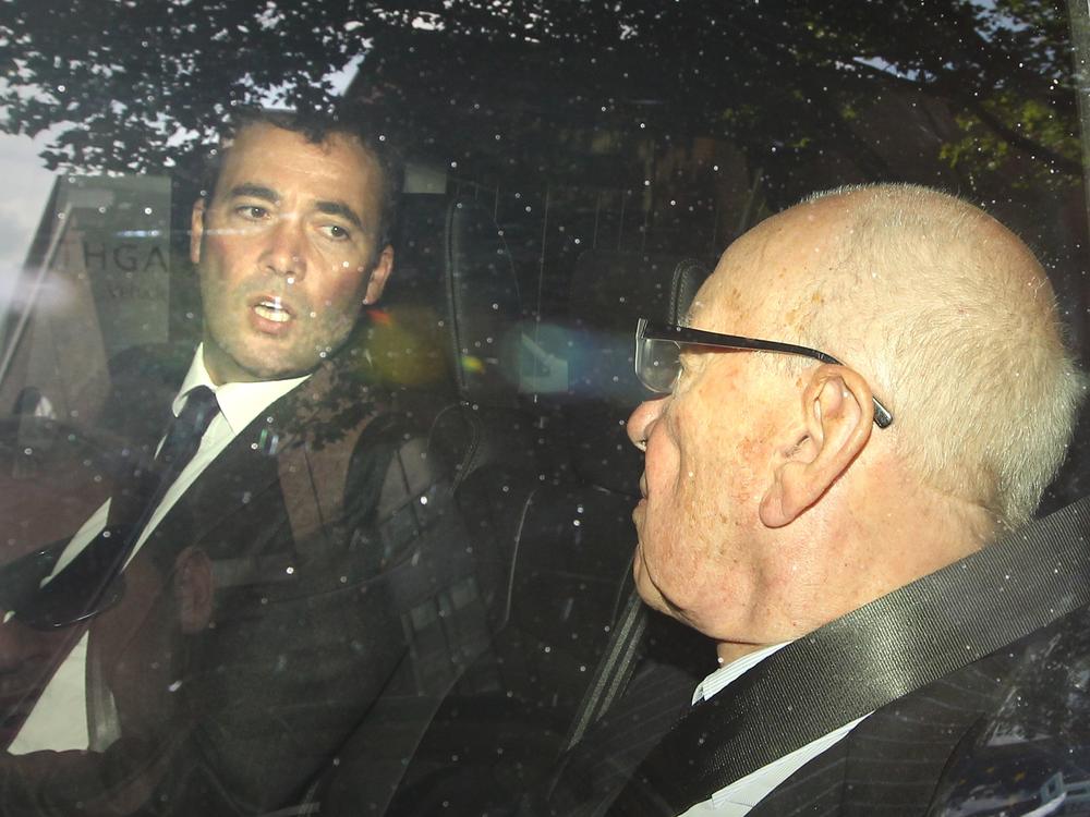 News Corp. Chairman Rupert Murdoch (R) rides with News International General Manager Will Lewis as they leave headquarters on July 15, 2011 in London. Lewis is now the publisher of <em>The Washington Post.</em>